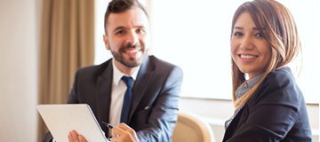 Professional woman and man in an office