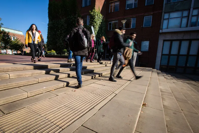 Students walking down some steps on a university campus